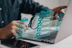 businessman use magnifying glass with checklist clipboard paper successfully complete business assignments