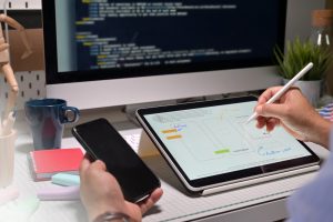 ui ux designer with tablet doing app mobile project