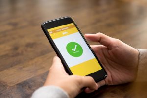 woman completing hotel room booking smartphone