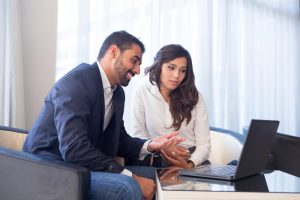 young business couple meeting with tech devices